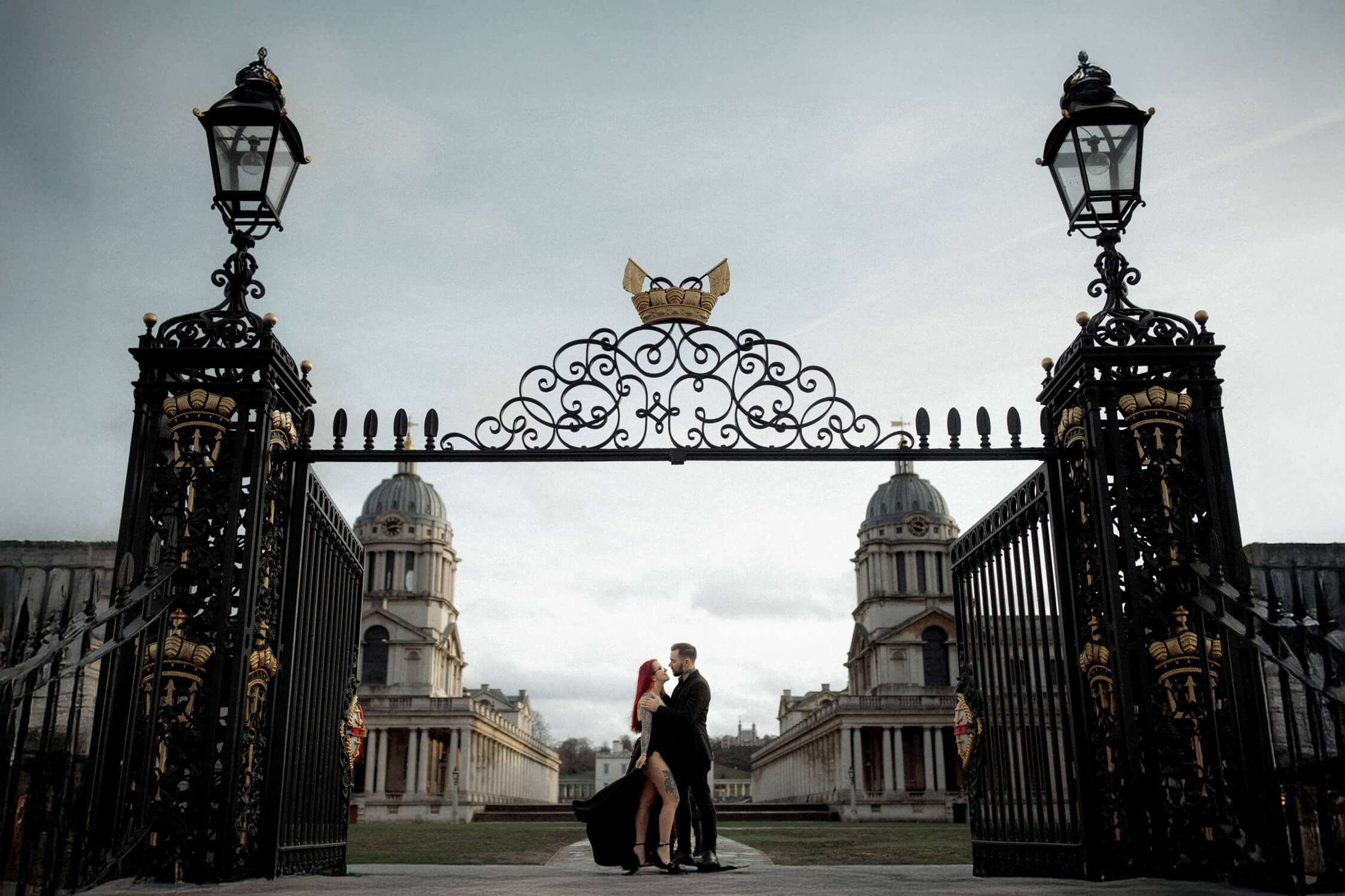 Couple embracing at Old Royal Naval College gates, one of the best places to elope in London with grand architecture.