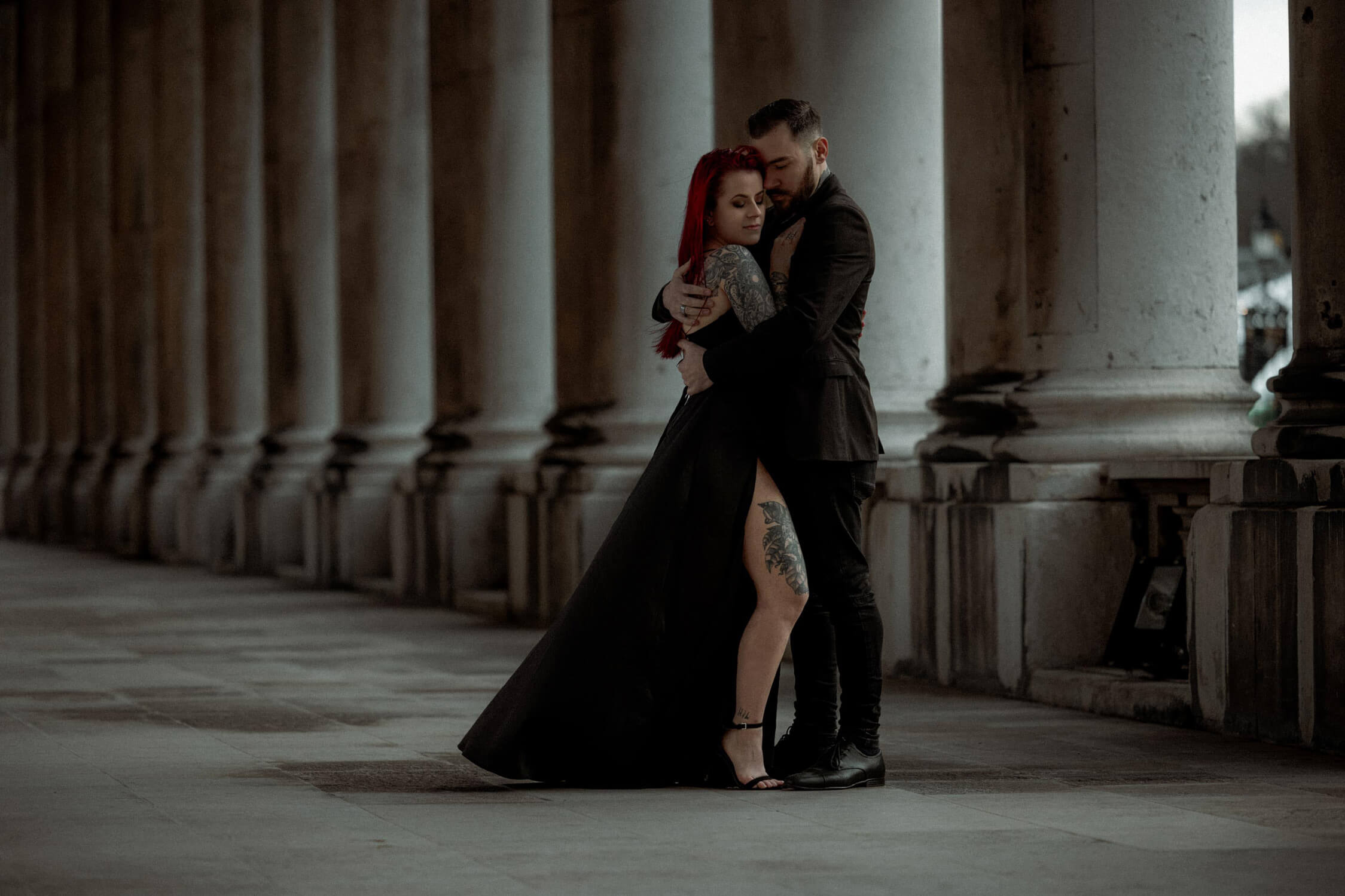 Couple embracing under colonnade at Old Royal Naval College, one of the best places to elope in London.